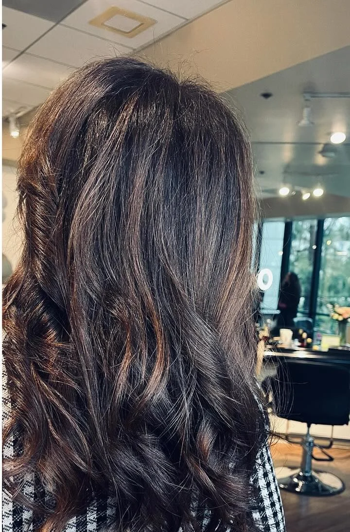 Long brunette waves with soft caramel dimension, colored and styled by Ani